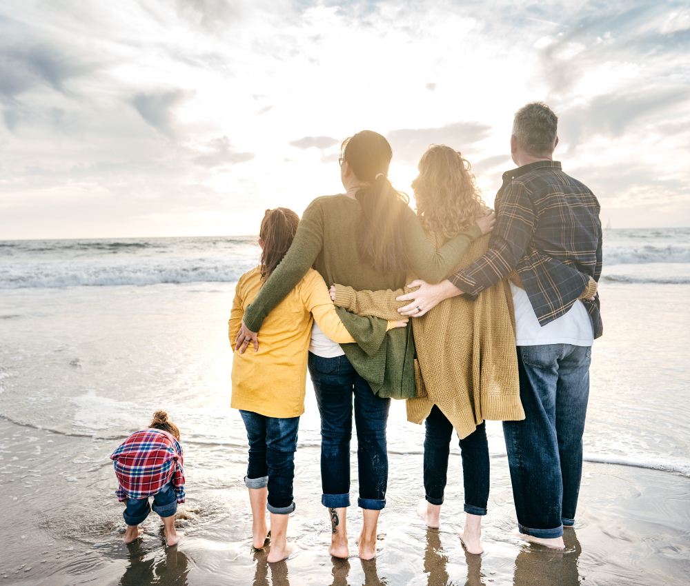 Family walking on beach knowing they have secure retirement savings