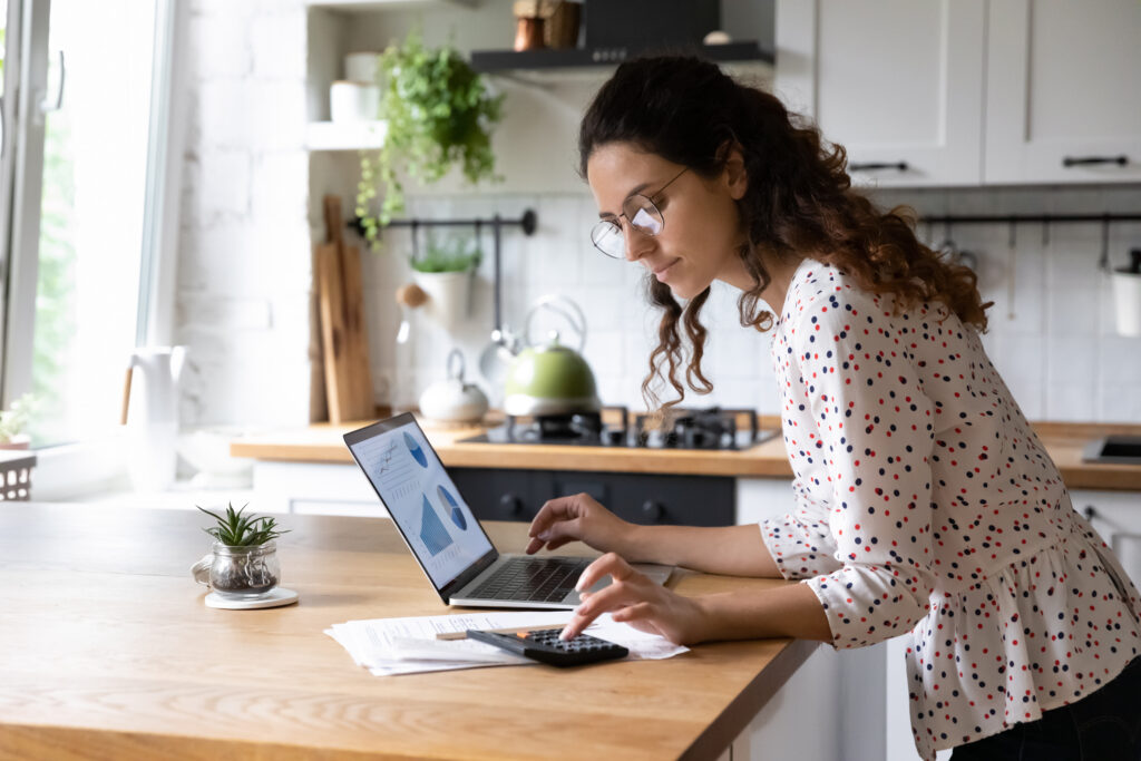 A woman studying on her computer about planning considerations for women