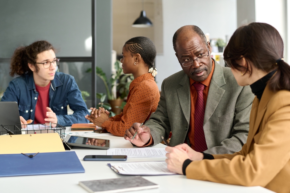A group of coworkers talking about retirement planning for entrepreneurs