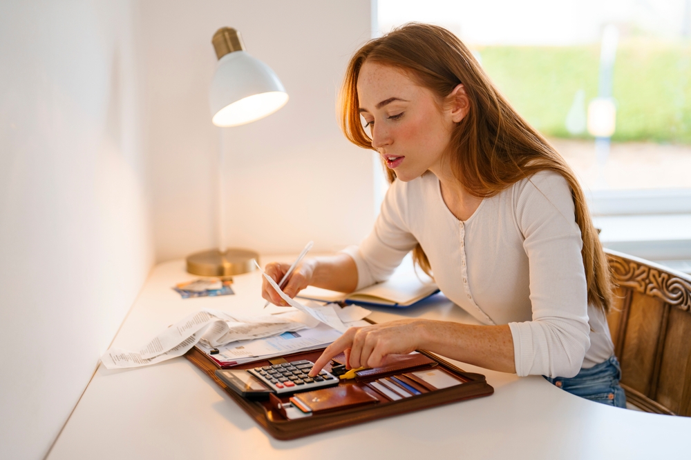 A girl looking over her financial plan on financial literacy month