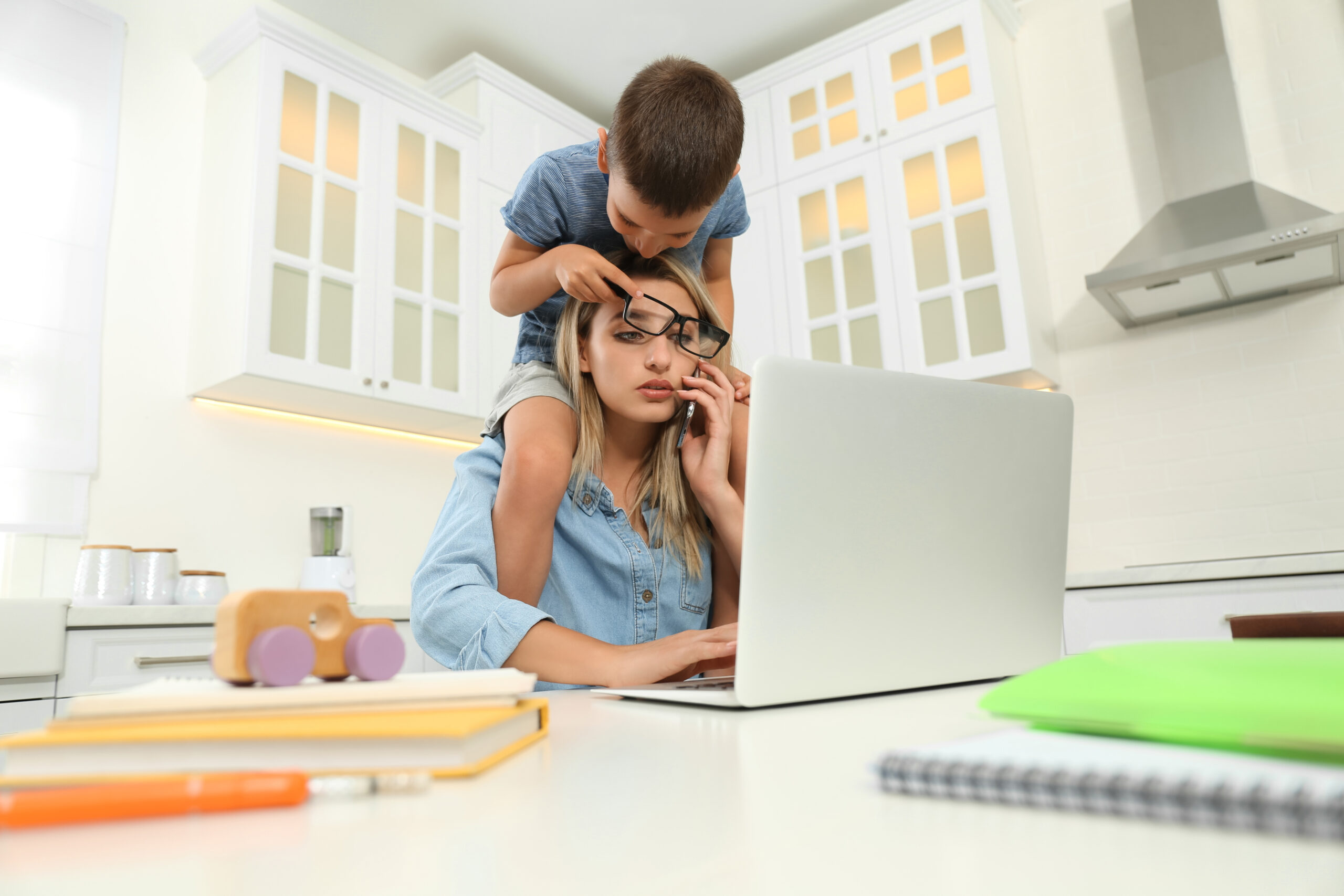 A mom with her son googling financial tips for busy parents
