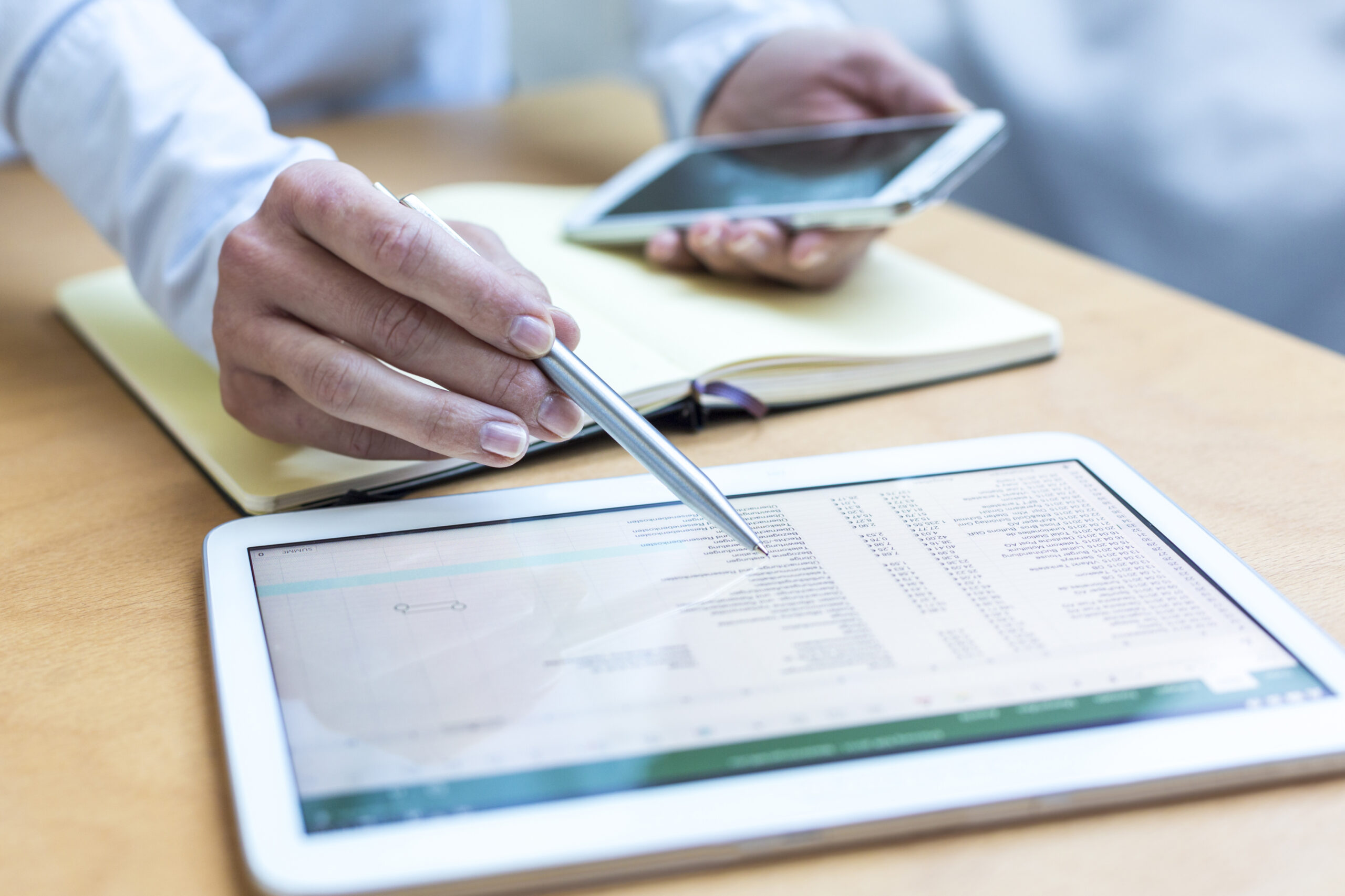 A person's hand using an apple pencil on a tablet on a blog about smart budgeting