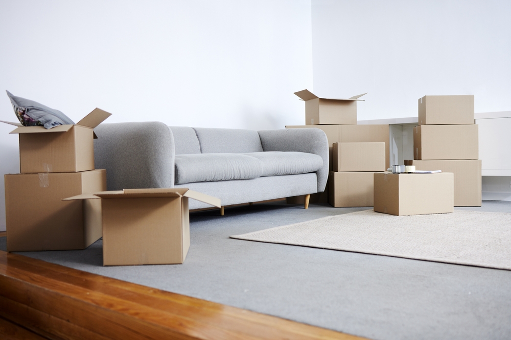 A photo of a living room with a couch and unpacked boxes on a blog about retirement planning