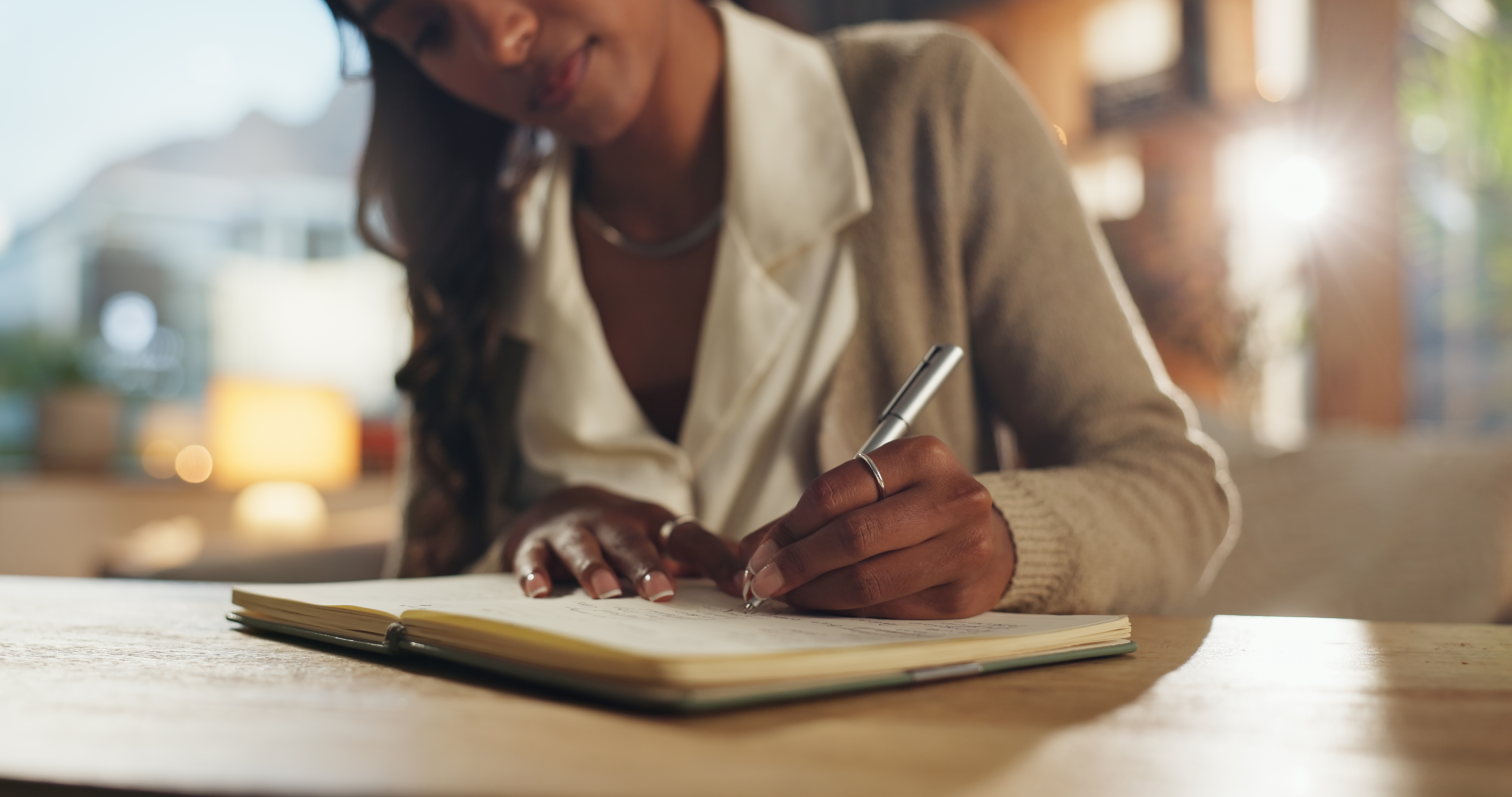 a woman writing in a journal about divorce financial planning