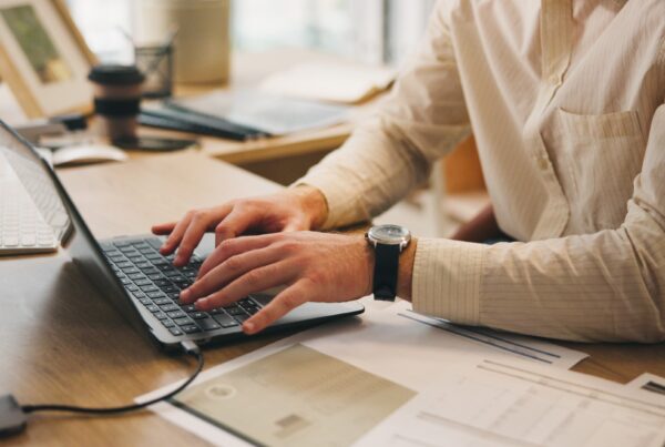 a person typing on a laptop on a blog about tax planning