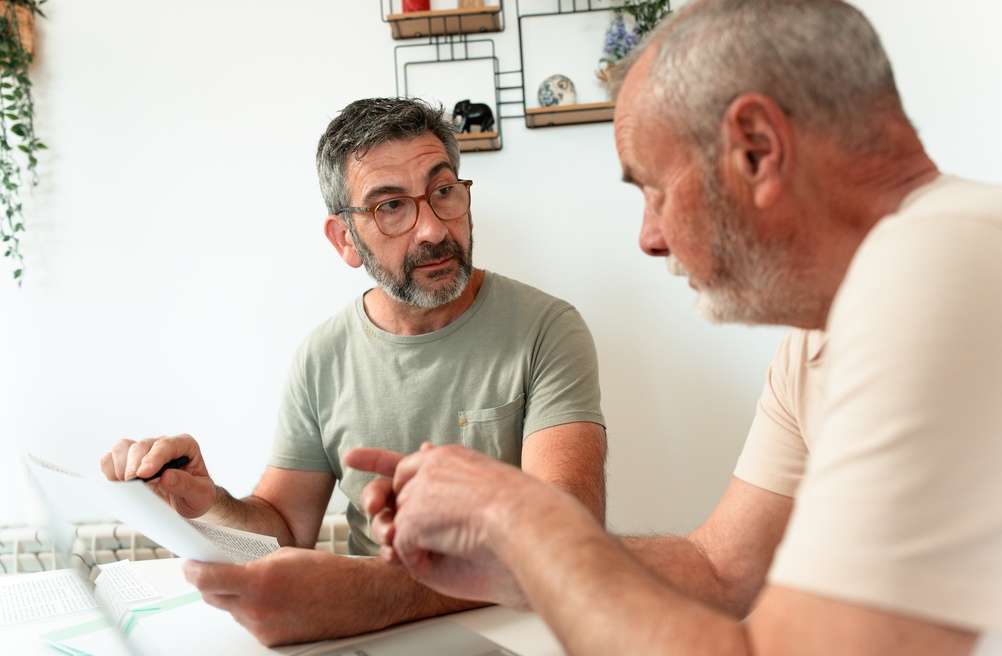 Two men discussing the emotional side of major financial decisions