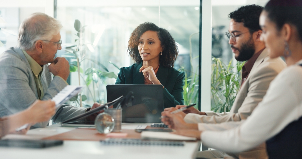A group of people around a table discussing financial continuity